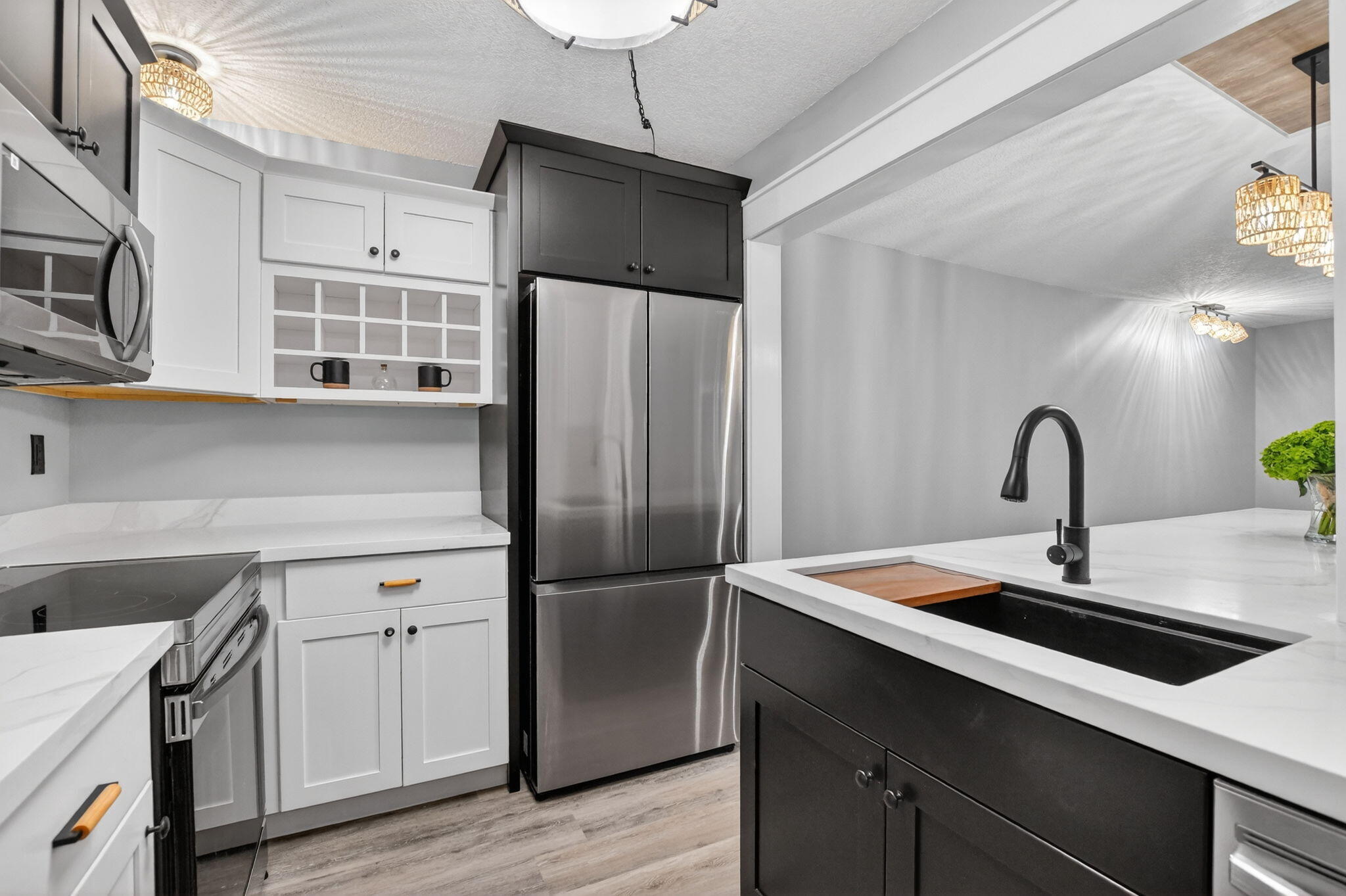 918 Southwest 9th St Circle, Unit 105 Boca Raton, FL 33486 - Photo 6 of 39 a kitchen with stainless steel appliances a refrigerator a sink a stove and cabinets