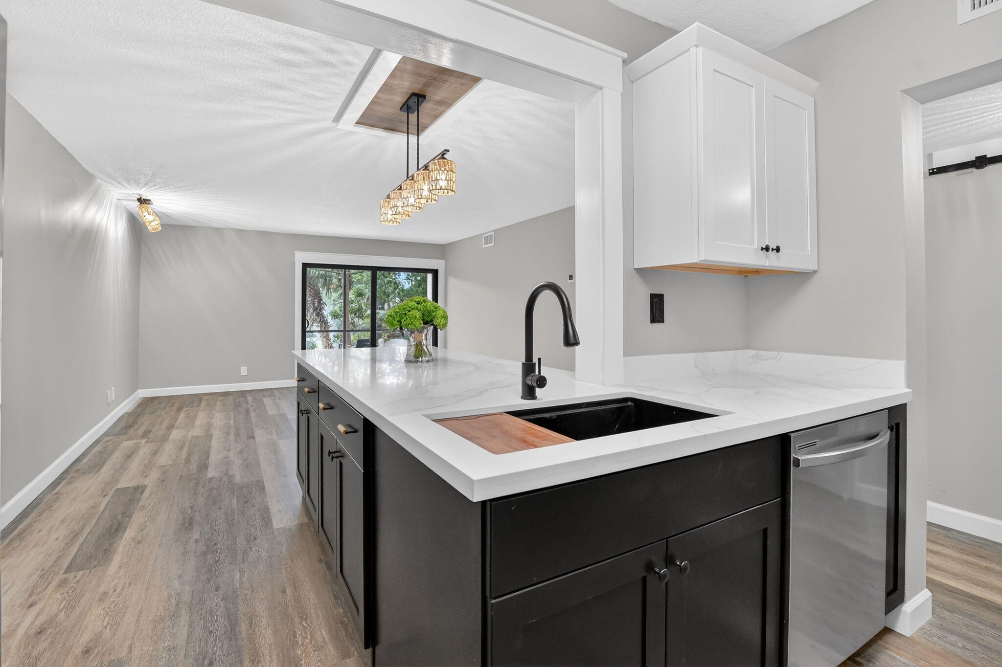 918 Southwest 9th St Circle, Unit 105 Boca Raton, FL 33486 - Photo 7 of 39 a kitchen with a sink cabinets and wooden floor