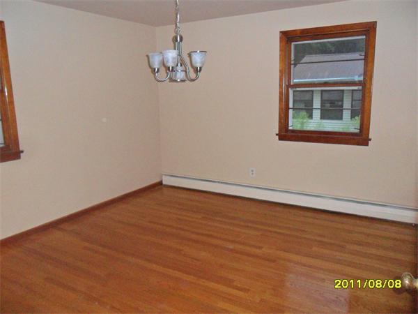 99 Mayher Street Springfield, MA 01104 - Photo 7 of 10 a view of an empty room with a window and wooden floor