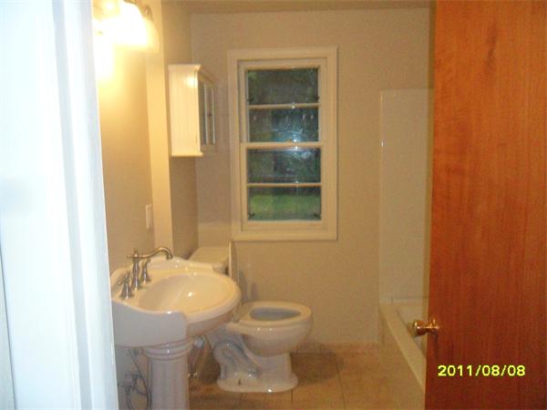 99 Mayher Street Springfield, MA 01104 - Photo 9 of 10 a bathroom with a sink and mirror with toilet