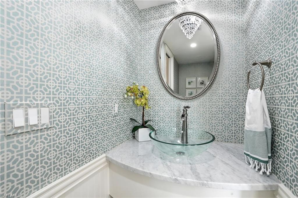 205 Springline Drive Naples, FL 34102 - Photo 11 of 26 a bathroom with a sink and a mirror