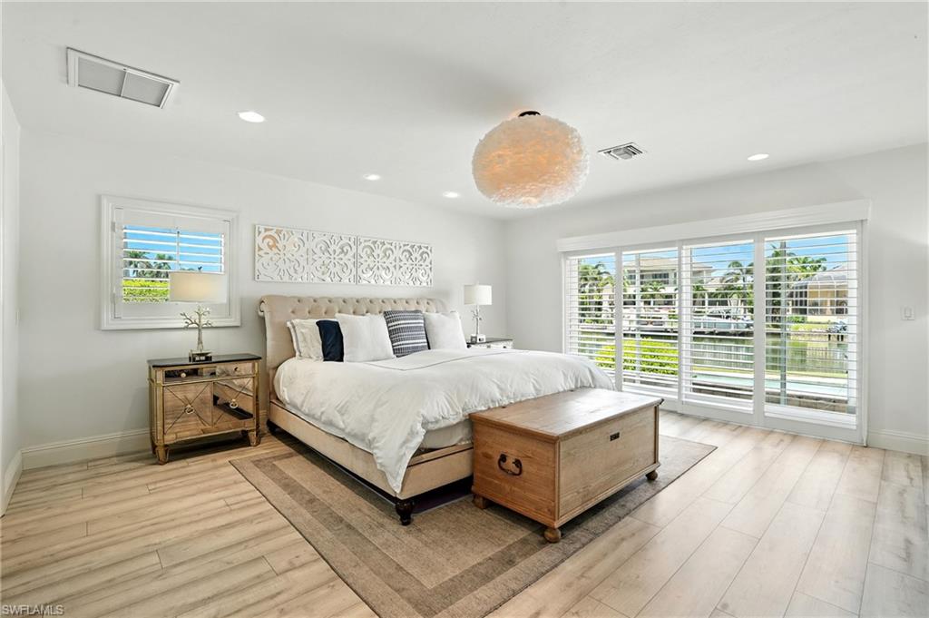 205 Springline Drive Naples, FL 34102 - Photo 12 of 26 a spacious bedroom with a bed and window