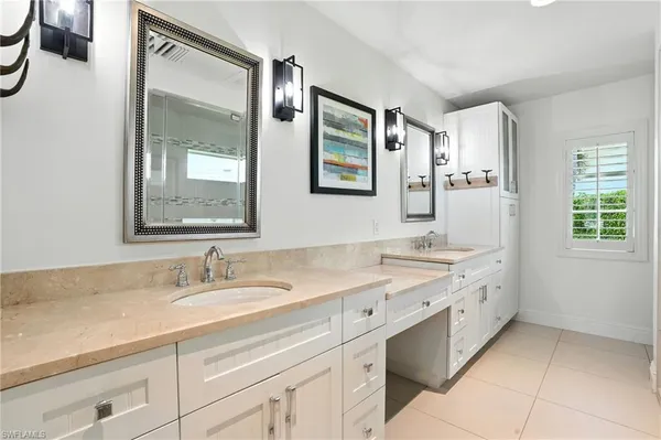a bathroom with a granite countertop sink mirror and double