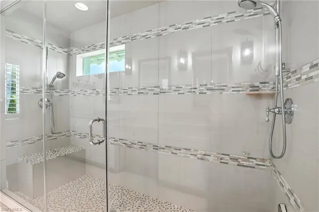 a bathroom with a glass shower door