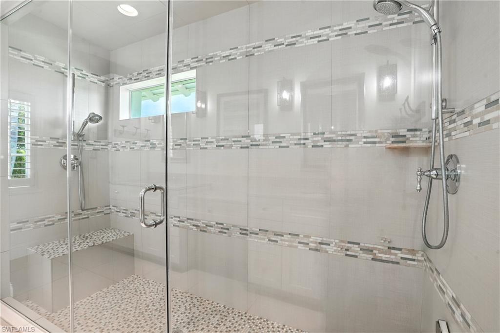 205 Springline Drive Naples, FL 34102 - Photo 14 of 26 a bathroom with a glass shower door