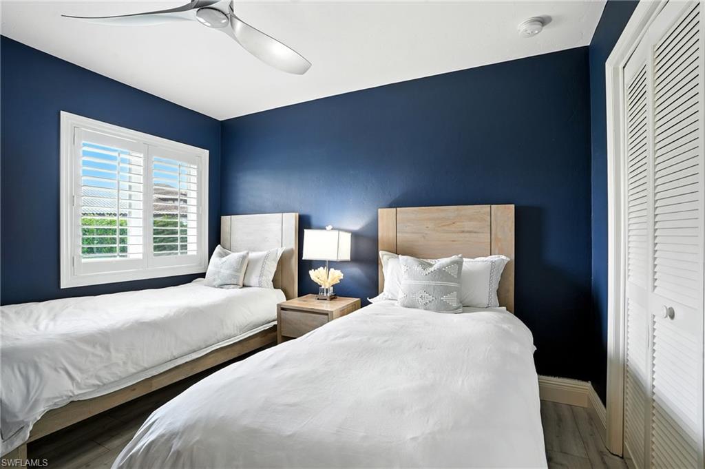 205 Springline Drive Naples, FL 34102 - Photo 15 of 26 a bedroom with two beds and a night stand