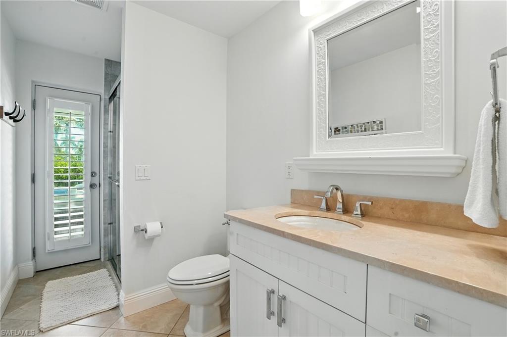 205 Springline Drive Naples, FL 34102 - Photo 19 of 26 a bathroom with a toilet sink and mirror