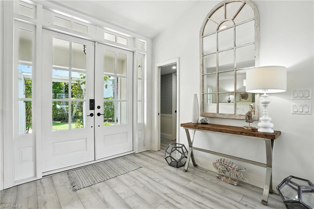 205 Springline Drive Naples, FL 34102 - Photo 2 of 26 a view of a livingroom with furniture and windows
