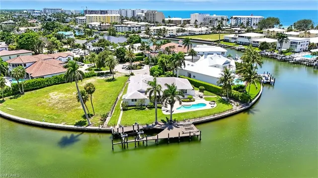 an aerial view of a house with a swimming pool yard and lake view