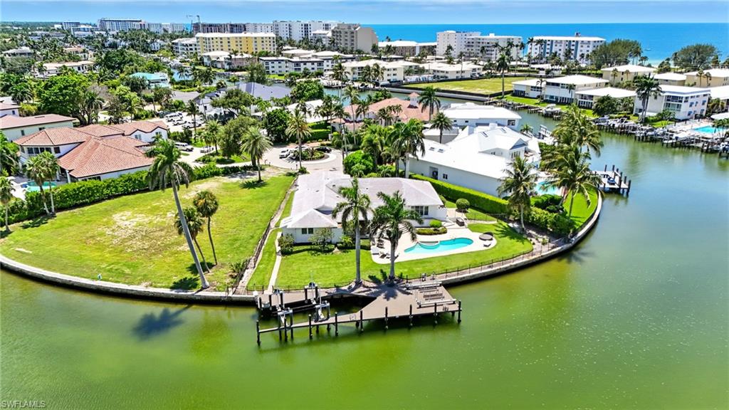 205 Springline Drive Naples, FL 34102 - Photo 22 of 26 an aerial view of a house with a swimming pool yard and lake view