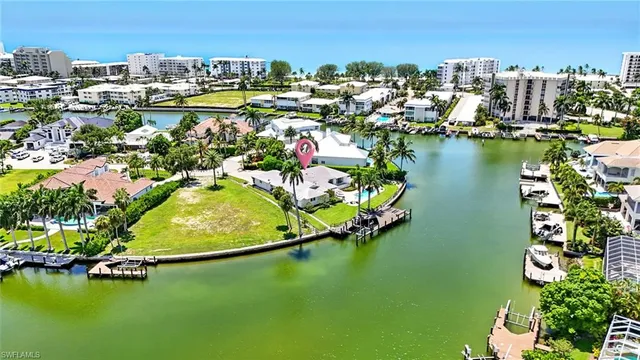 an aerial view of water body with boats and residential houses with outdoor space