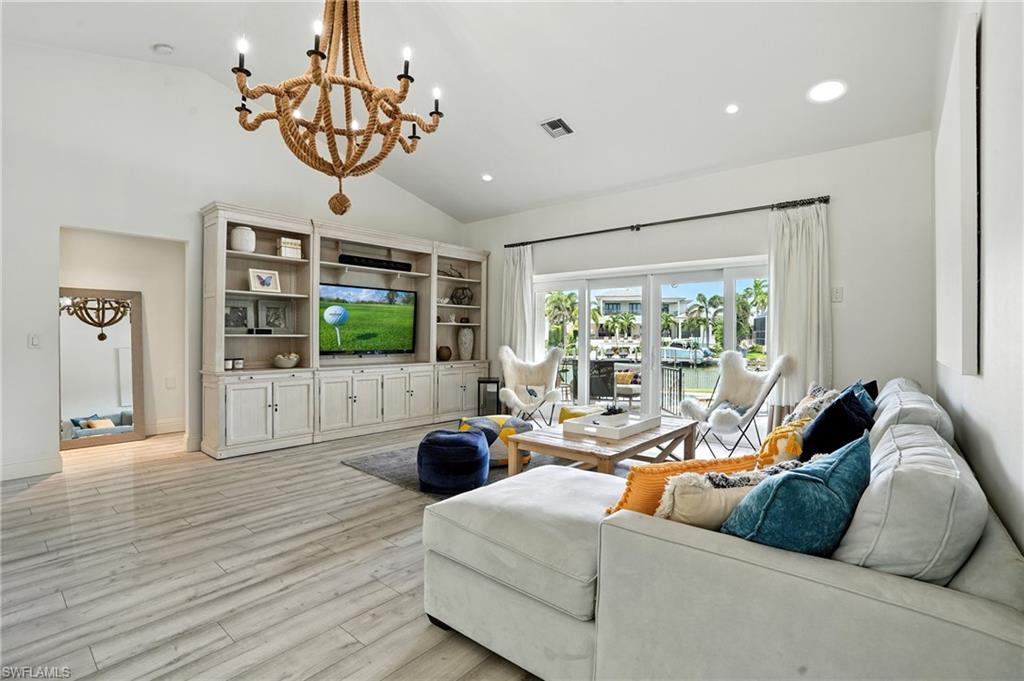 205 Springline Drive Naples, FL 34102 - Photo 3 of 26 a living room with furniture large window and wooden floor
