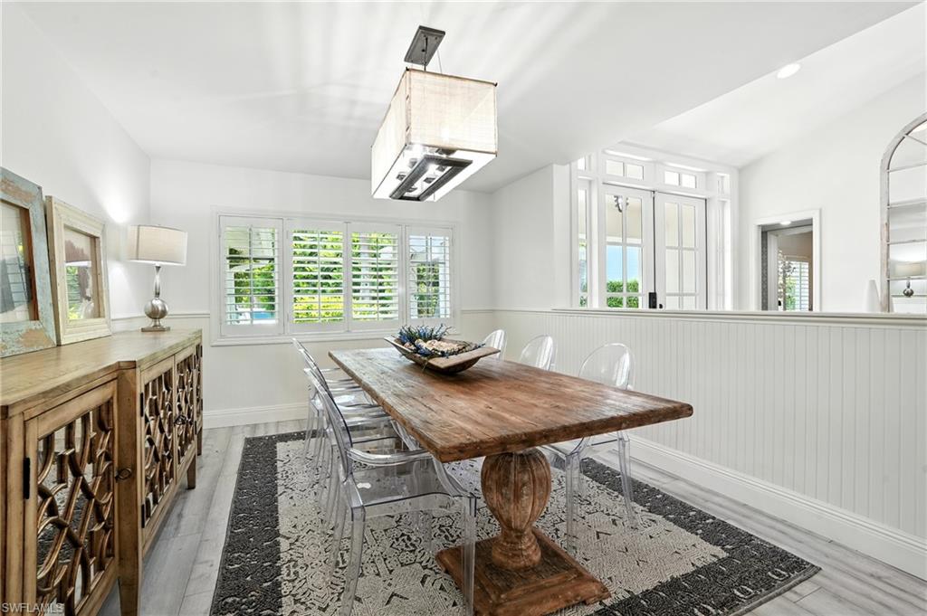 205 Springline Drive Naples, FL 34102 - Photo 4 of 26 a view of a kitchen with a table and chairs