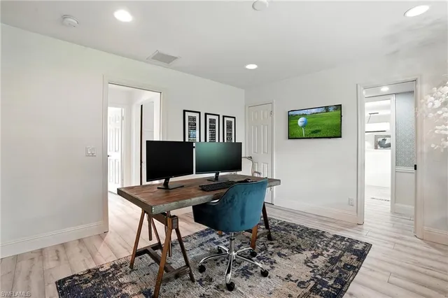 a workspace with furniture and wooden floor