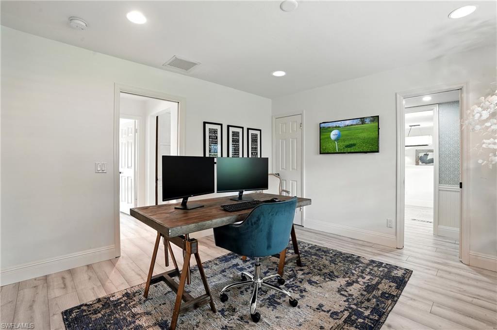 205 Springline Drive Naples, FL 34102 - Photo 10 of 26 a workspace with furniture and wooden floor