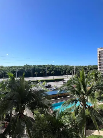 a view of a lake with lawn chairs