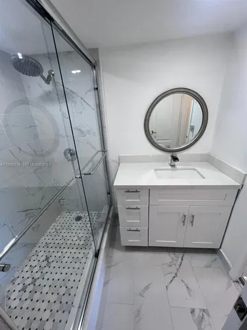 a bathroom with a sink mirror vanity and toilet
