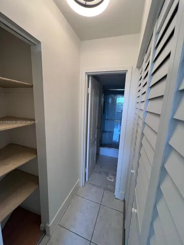 a view of a hallway with a chair