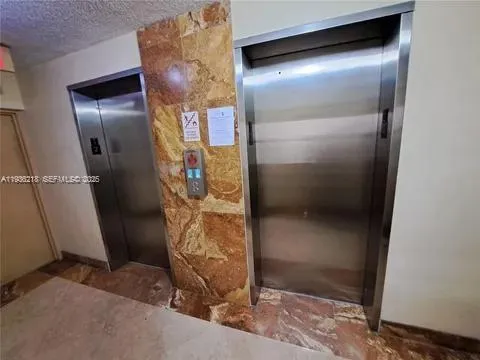 a bathroom with a glass door shower and a sink