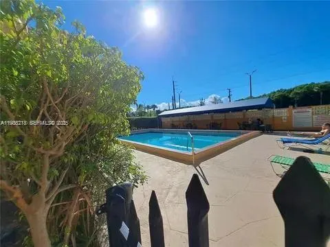 a view of a swimming pool with a yard