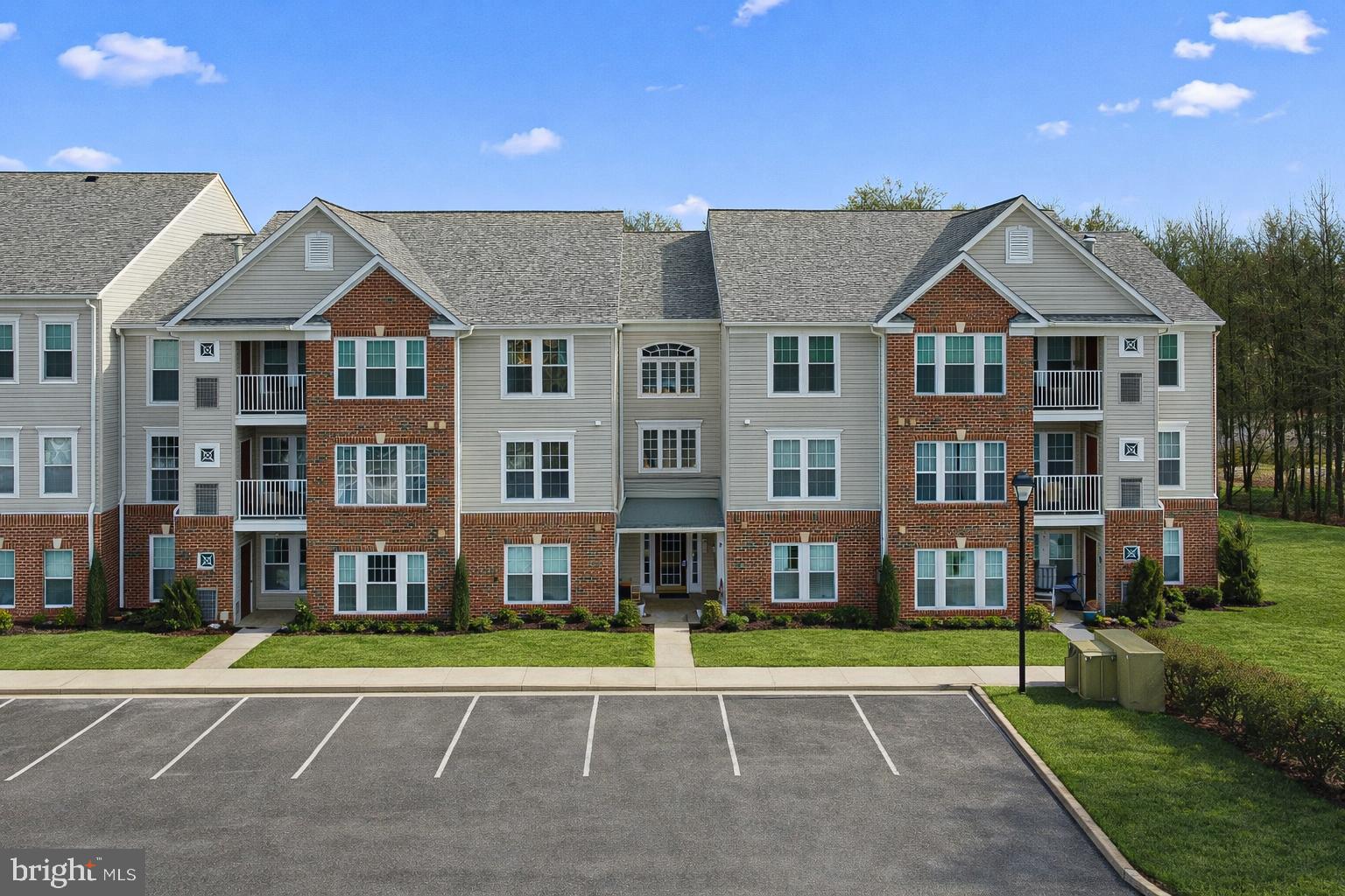 9 Brook Farm Court, Unit 9G Perry Hall, MD 21128 - Photo 1 of 33 a front view of a building with a yard