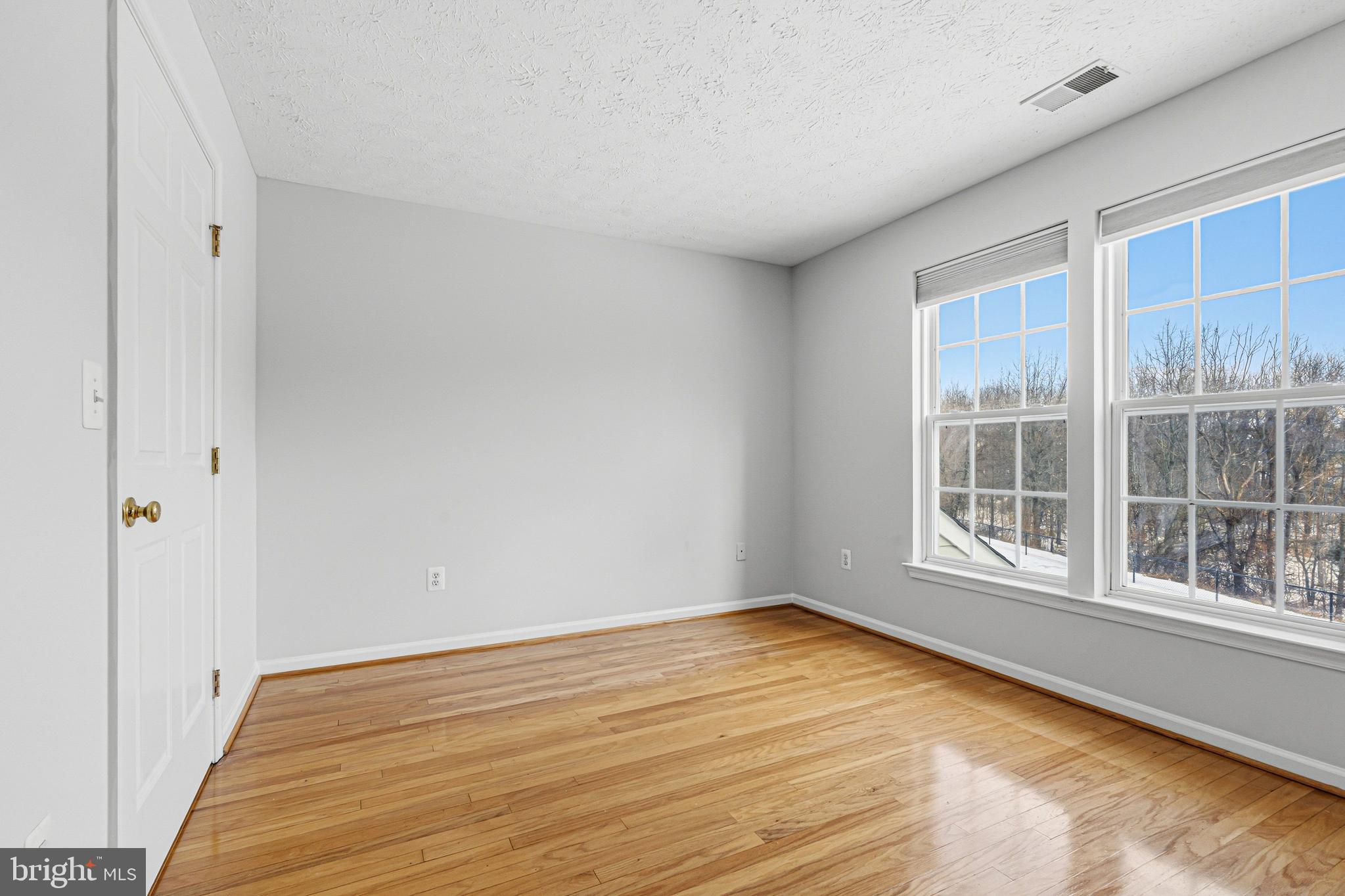 9 Brook Farm Court, Unit 9G Perry Hall, MD 21128 - Photo 11 of 33 a view of empty room with wooden floor and fan