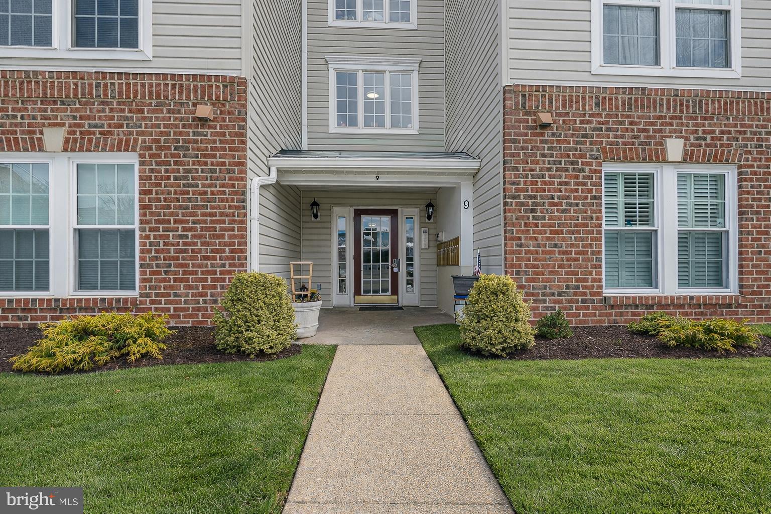 9 Brook Farm Court, Unit 9G Perry Hall, MD 21128 - Photo 2 of 33 a front view of a house with garden