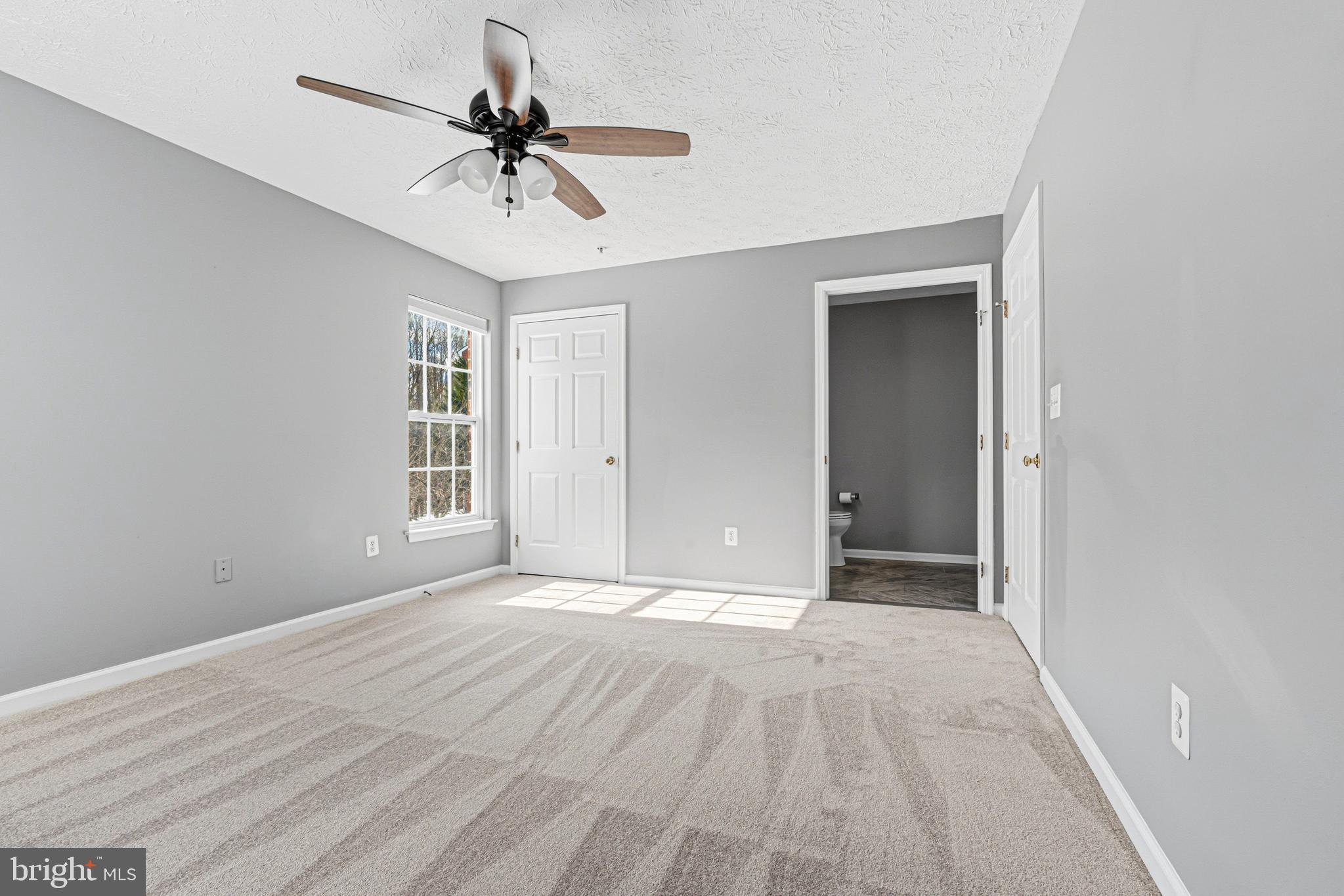 9 Brook Farm Court, Unit 9G Perry Hall, MD 21128 - Photo 23 of 33 a view of empty room with wooden floor and ceiling fan