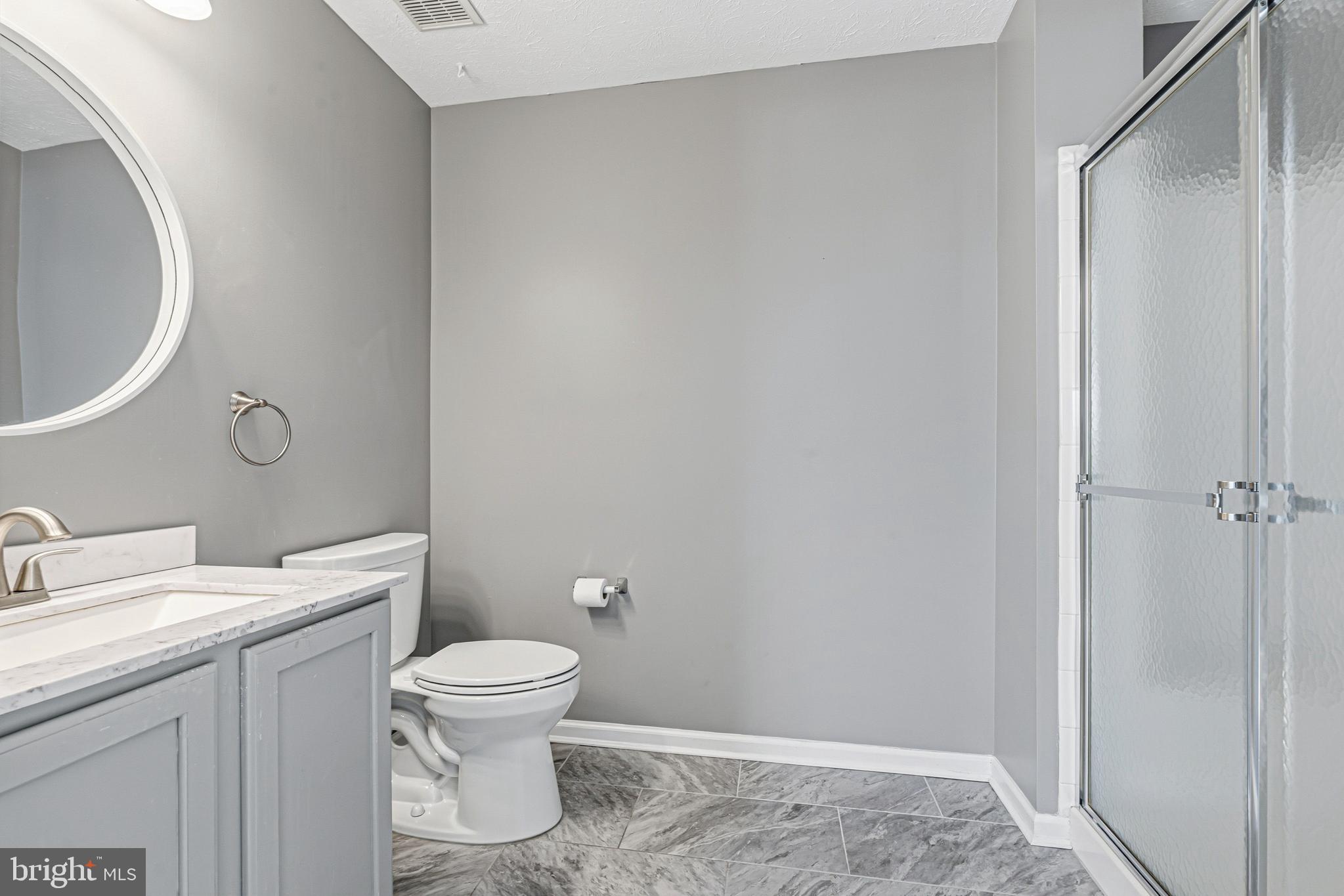 9 Brook Farm Court, Unit 9G Perry Hall, MD 21128 - Photo 25 of 33 a bathroom with a toilet a sink and a mirror