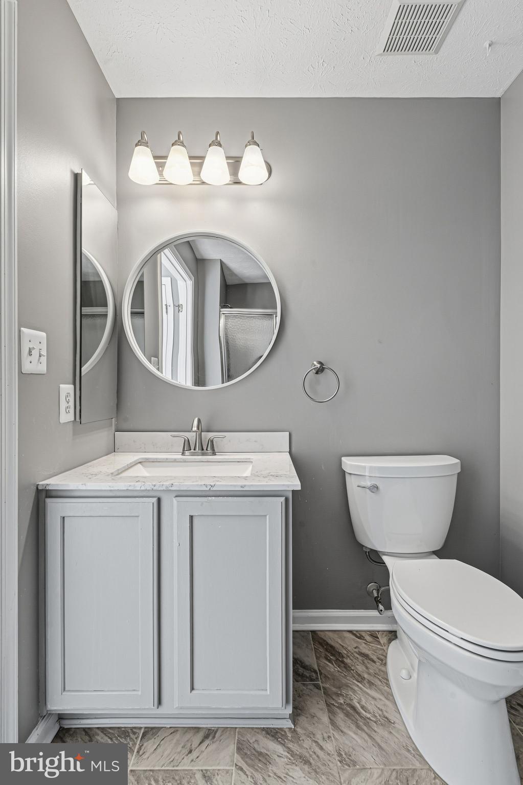 9 Brook Farm Court, Unit 9G Perry Hall, MD 21128 - Photo 27 of 33 a bathroom with a toilet a sink and a mirror