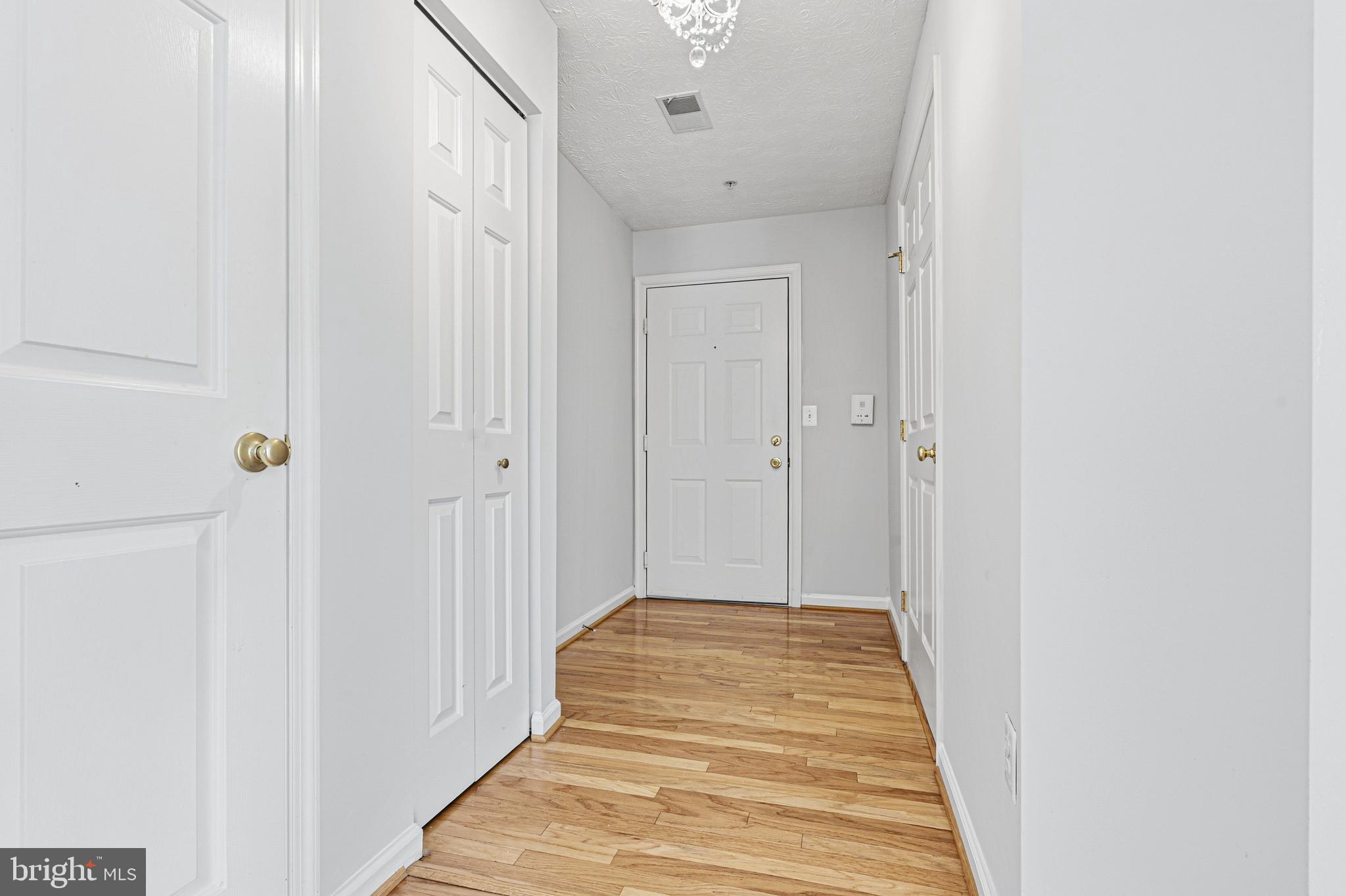 9 Brook Farm Court, Unit 9G Perry Hall, MD 21128 - Photo 4 of 33 a view of a hallway with wooden floor