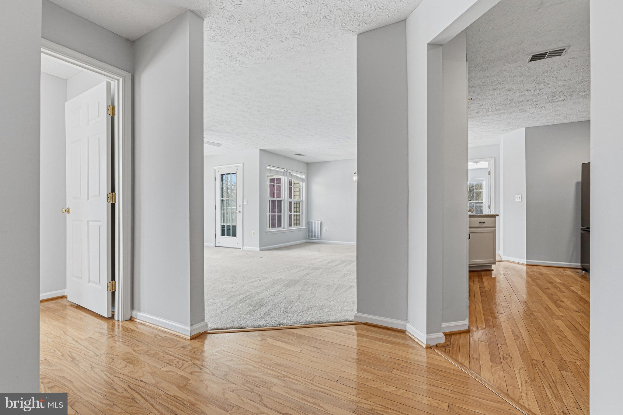 9 Brook Farm Court, Unit 9G Perry Hall, MD 21128 - Photo 6 of 33 a view of a hallway with wooden floor and staircase