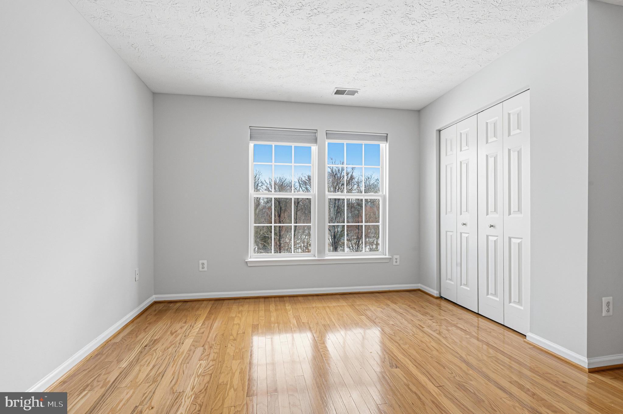 9 Brook Farm Court, Unit 9G Perry Hall, MD 21128 - Photo 10 of 33 an empty room with wooden floor and windows