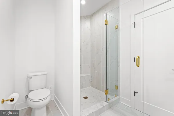 a bathroom with a toilet and a shower