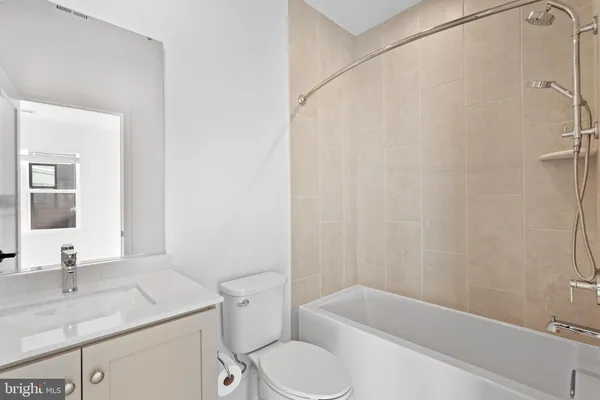 a bathroom with a sink toilet vanity and shower