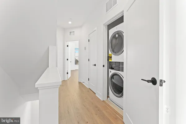 a view of a hallway with washer and dryer