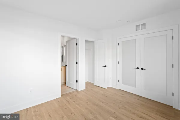 a view of hallway with wooden floor
