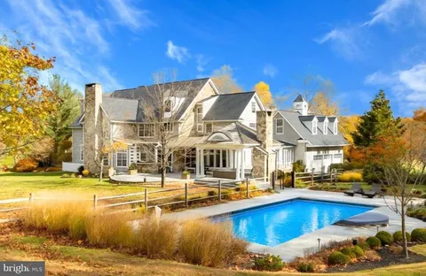 a view of a swimming pool with outdoor seating