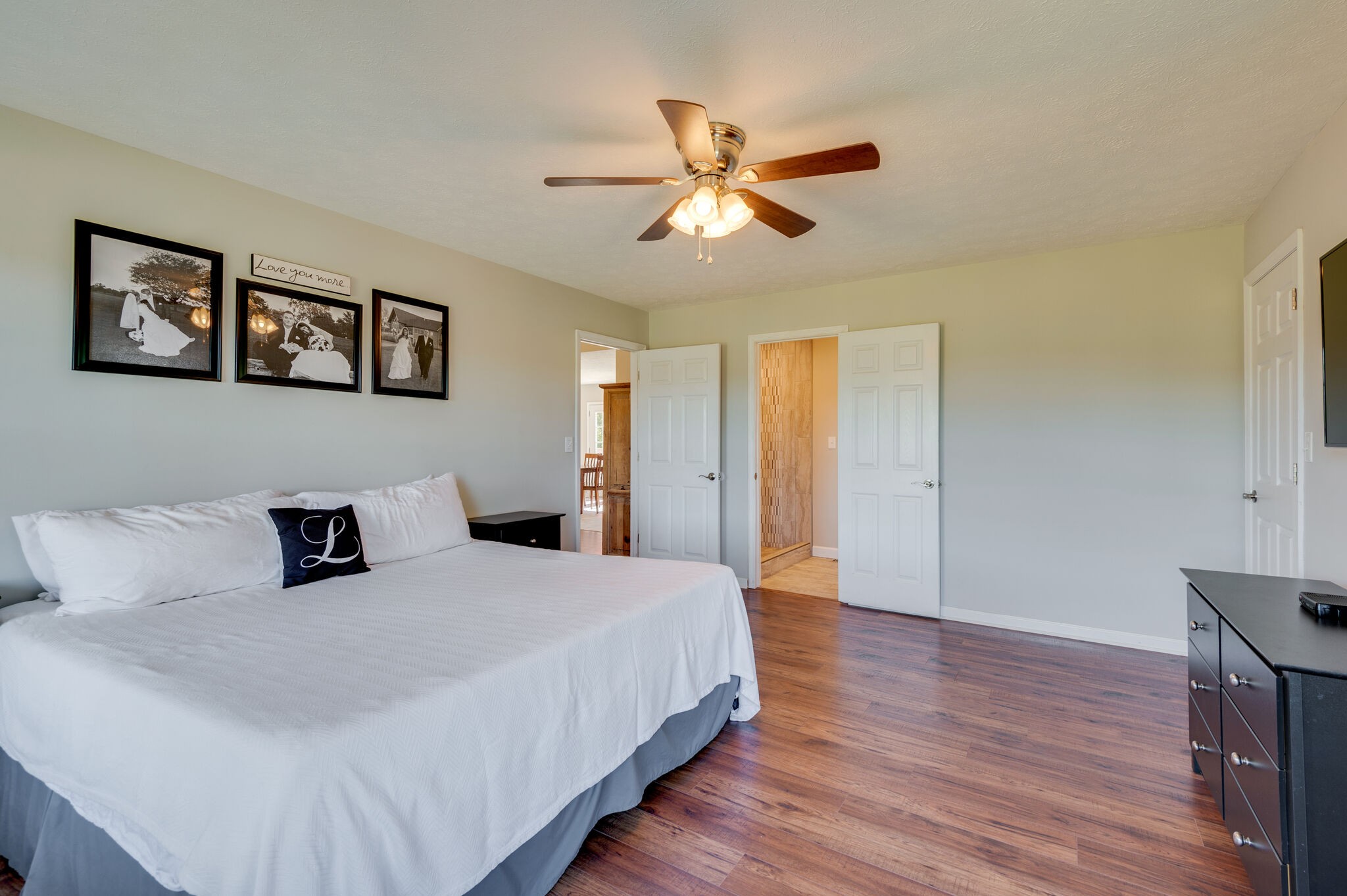 1549 Center Star Road Columbia, TN 38401 - Photo 23 of 50 a bedroom with a large bed and a chandelier