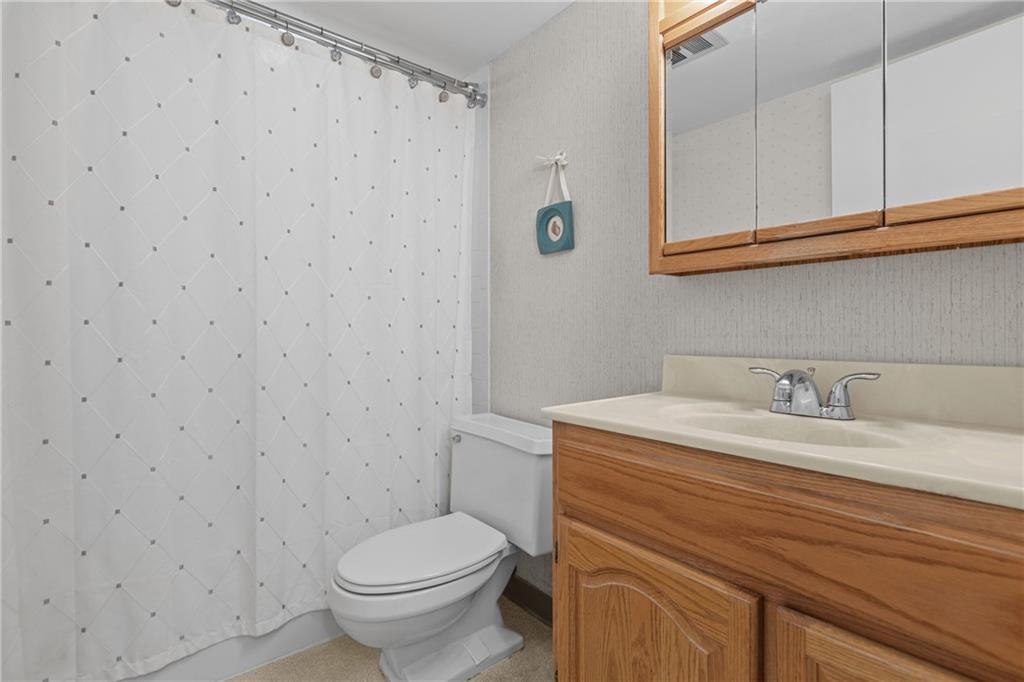 5 Bayard Road, Unit 307 Pittsburgh, PA 15213 - Photo 8 of 20 a bathroom with a granite countertop toilet sink and mirror