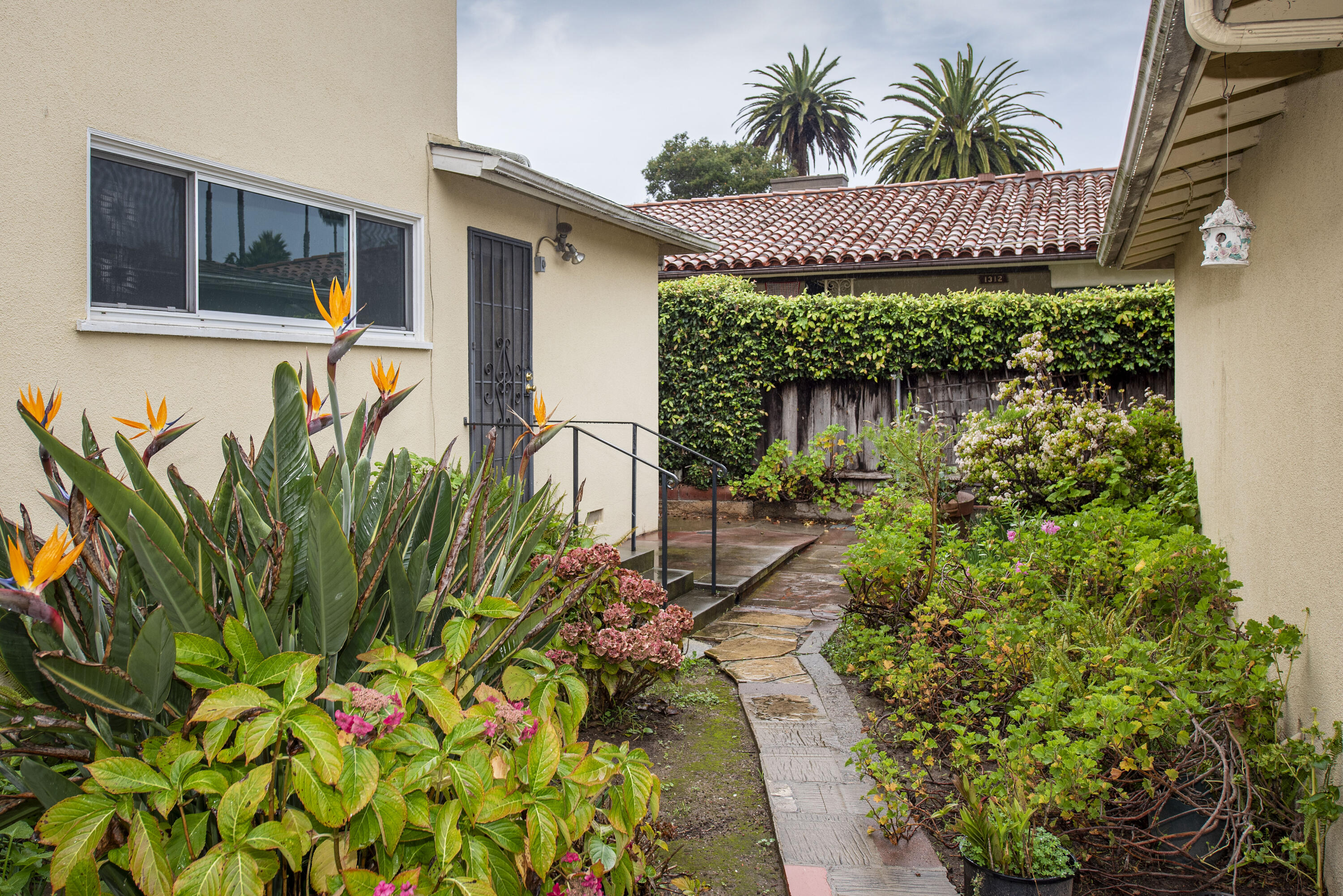 1308 Bath Street Santa Barbara, CA 93101 - Photo 17 of 19 a front view of a house with a yard with potted plants