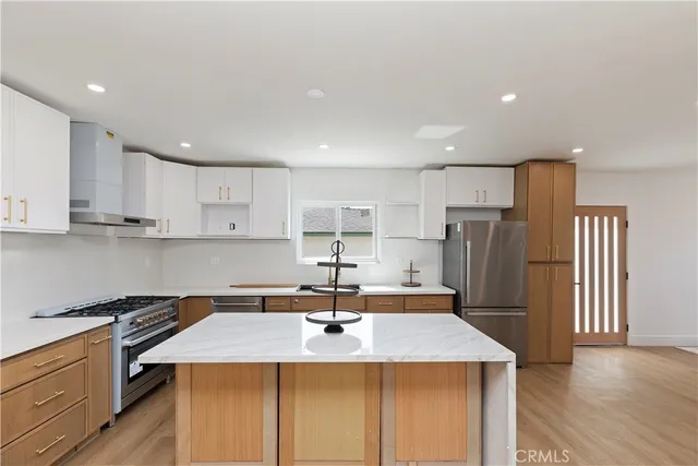 a kitchen with a sink a refrigerator and a stove