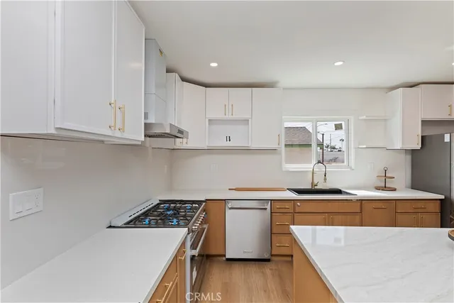 a kitchen that has a sink and a stove in it