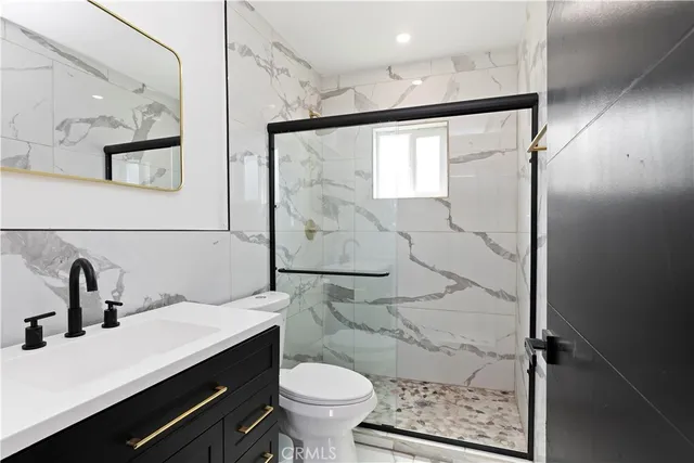 a bathroom with a sink toilet and shower