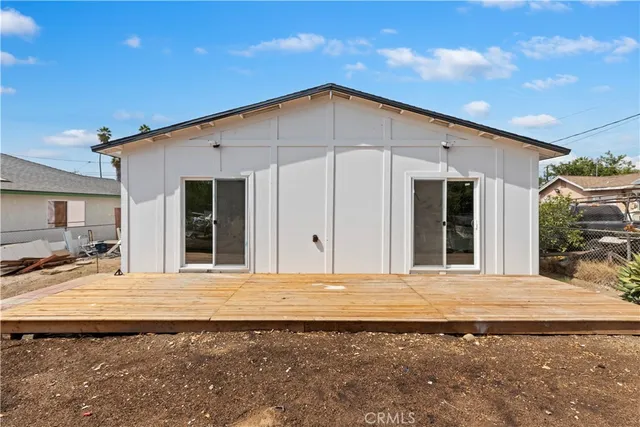 a view of a house with large windows and a small yard
