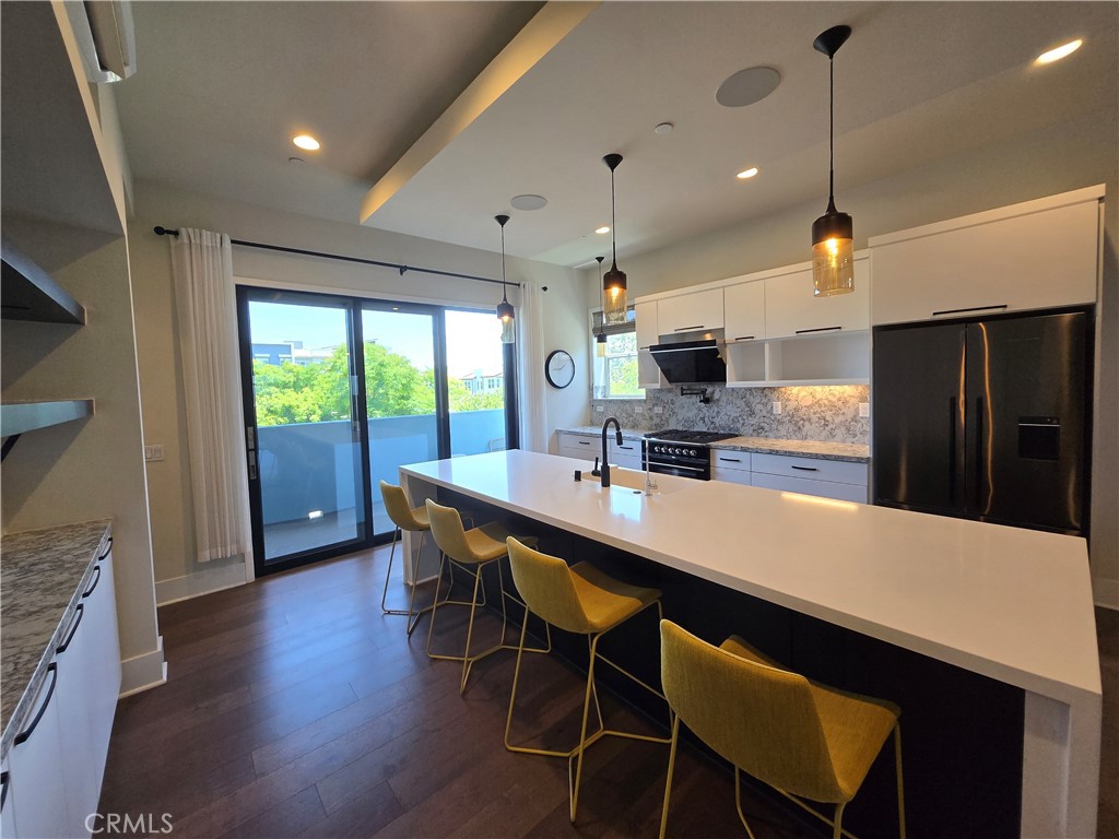 753 Site Drive Brea, CA 92821 - Photo 12 of 28 a kitchen with stainless steel appliances a dining table chairs and wooden floor