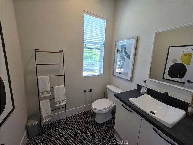 a bathroom with a sink toilet a mirror and vanity