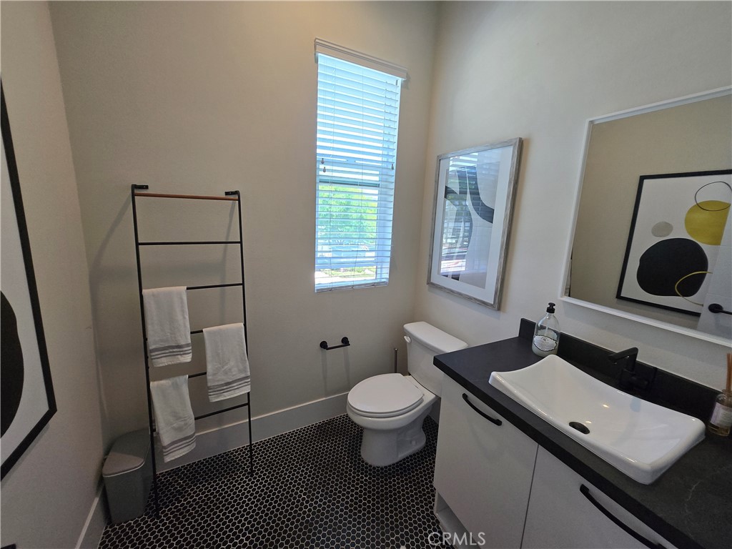 753 Site Drive Brea, CA 92821 - Photo 14 of 28 a bathroom with a sink toilet a mirror and vanity