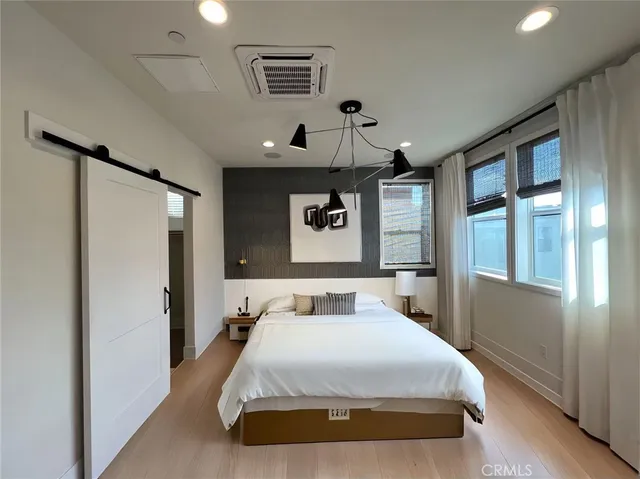 a bedroom with a large bed and a window
