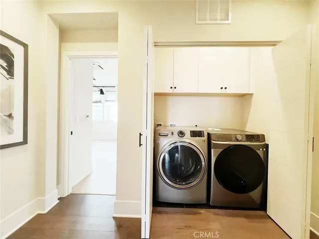 a view of a hallway with washer and dryer